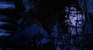 As Aleera attempts to feed on Anna's blood, the Frankenstein Monster crashes through the barred window.