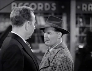 Grover given reassurance by Butch with a wink