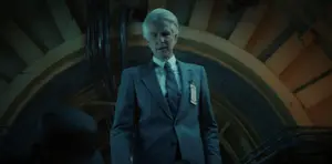 Brenner walking towards Eleven after the guards sedate her when she tries to run off in terror.