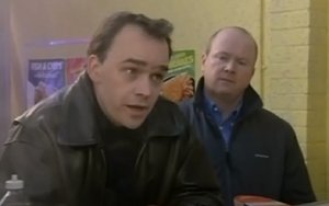 Phil watches as Mark describes his relationship with Lisa (2001).