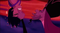 Jafar taunting Aladdin as he hangs him upside down.