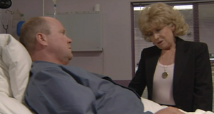 Phil is visited by Peggy in hospital as he recovers from crashing in the River Thames from his criminal heist with Grant (1999).