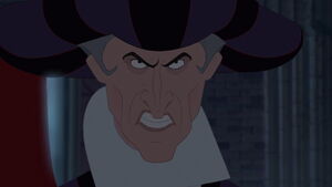 Frollo snarls with rage when the Archdeacon defends Esmeralda, furiously reminding Frollo of the last time the Archdeacon impeded him.