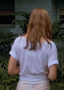 A wet Kelly with her black thong visible through her wet shorts.