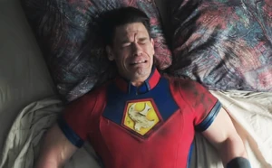 Peacemaker cries while listening to music, expressing regret for killing Flag.