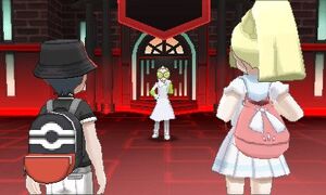 Lillie and the player meeting Faba outside Team Rainbow Rocket's Castle.