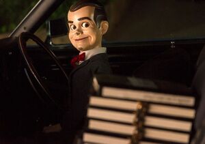 Slappy in a car with the Goosebumps manuscripts.