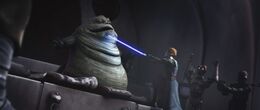 Anakin brandishes his lightsaber against Jabba.