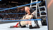 AJ Styles brutally assaulting an injured Ellsworth during a ladder match.