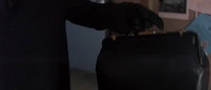 Adriana with her bag that has the garrote in it.