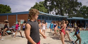 Billy walking past his coworker, Heather Holloway.