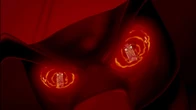 Jafar's face appearing through the glowing eyes of his staff.