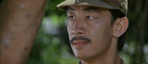Lieutenant Tay abusing Rambo after capturing him