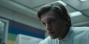 One slipping a keycard under the table to give to Eleven.