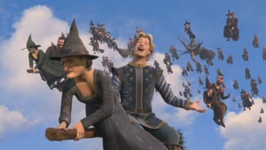 Charming on one of the witches' backs laughing evilly.