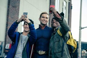 Homelander takes a selfie with fans that he just saved.