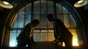 Oswald talks to Nygma in Arkham Asylum.