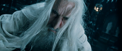 Saruman falls to the floor after Gandalf frees King Théoden from his spell