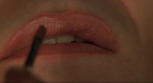 Bill putting on lipstick.