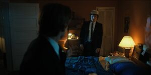Andy searching a bedroom where Jason tells him to keep looking.