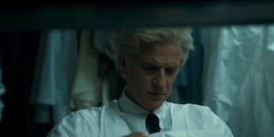 Brenner changing into a hazmat suit.