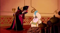 Jafar bowing to the Sultan while listening him express his problems with his daughter, Jasmine.