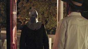 Tom as The Executioner eyes Bryan.