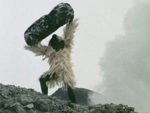 Snowman tossing a rock.