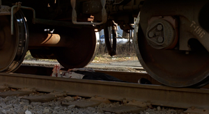 Jonathan's dead body lying beneath the train.
