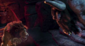 He flings him at the edge of a cliff over a pit of lava.