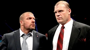 Kane and Triple H watching Randy Orton and The Shield take out The Big Show.