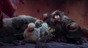 Kazar looks up to see the giant "Great Him statue" about to collapse on him.