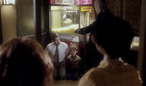 Adam and his father being held at gunpoint.