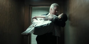 Brenner holding an exhausted Eleven in his arms.