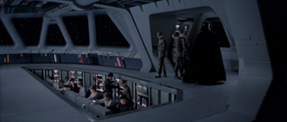 Darth Vader approaches Admiral Piett on the Executor bridge.