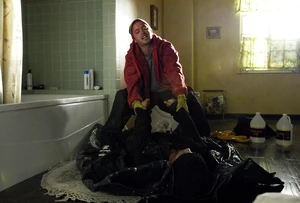 Jesse putting Emilio's corpse into the bathtub.