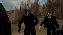 Garrett and Coulson from the Guest House just as it explodes.