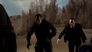 Garrett and Coulson escaping from the Guest House explosion.
