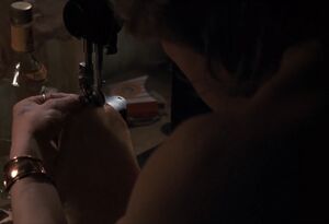 Bill sewing a piece of his skin suit.