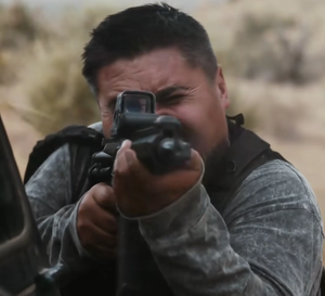 A mercenary firing at Mike.