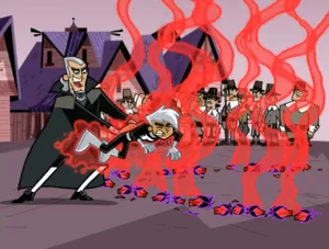 Vlad sadistically shoves Danny into the circle o the blood of blossoms.