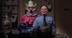 Jumbo using Officer Mooney as a ventriloquist dummy