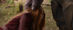 A heartbroken Scarlet Witch being comforted by Thanos.