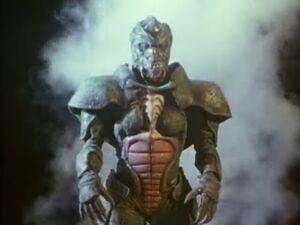 Riga emerges from his human host to do battle.