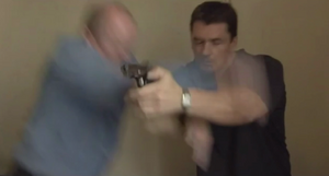 Phil ambushes Dan as the latter attempts to shoot him (2001).