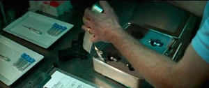 Birkin opens a case containing samples of the G-Virus.