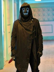 A photo of Wyatt, in costume, holding a bloody knife.