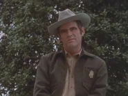 Asmodeus in the form of the normal man disguised as a park ranger.