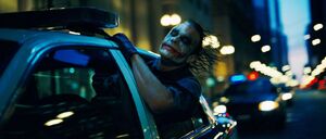 Joker escapes once again and boards a police car.