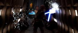 Vader and Kenobi scratch the walls with their sabers causing sparks to erupt.